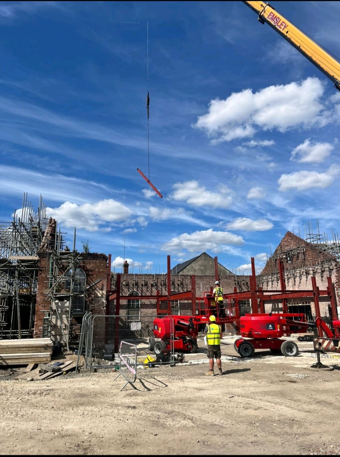 Operatives carrying out crane-assisted steelwork