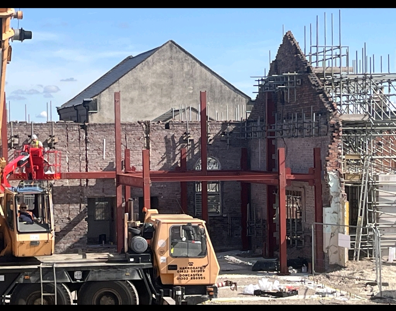 Steel frame erection and access equipment on site