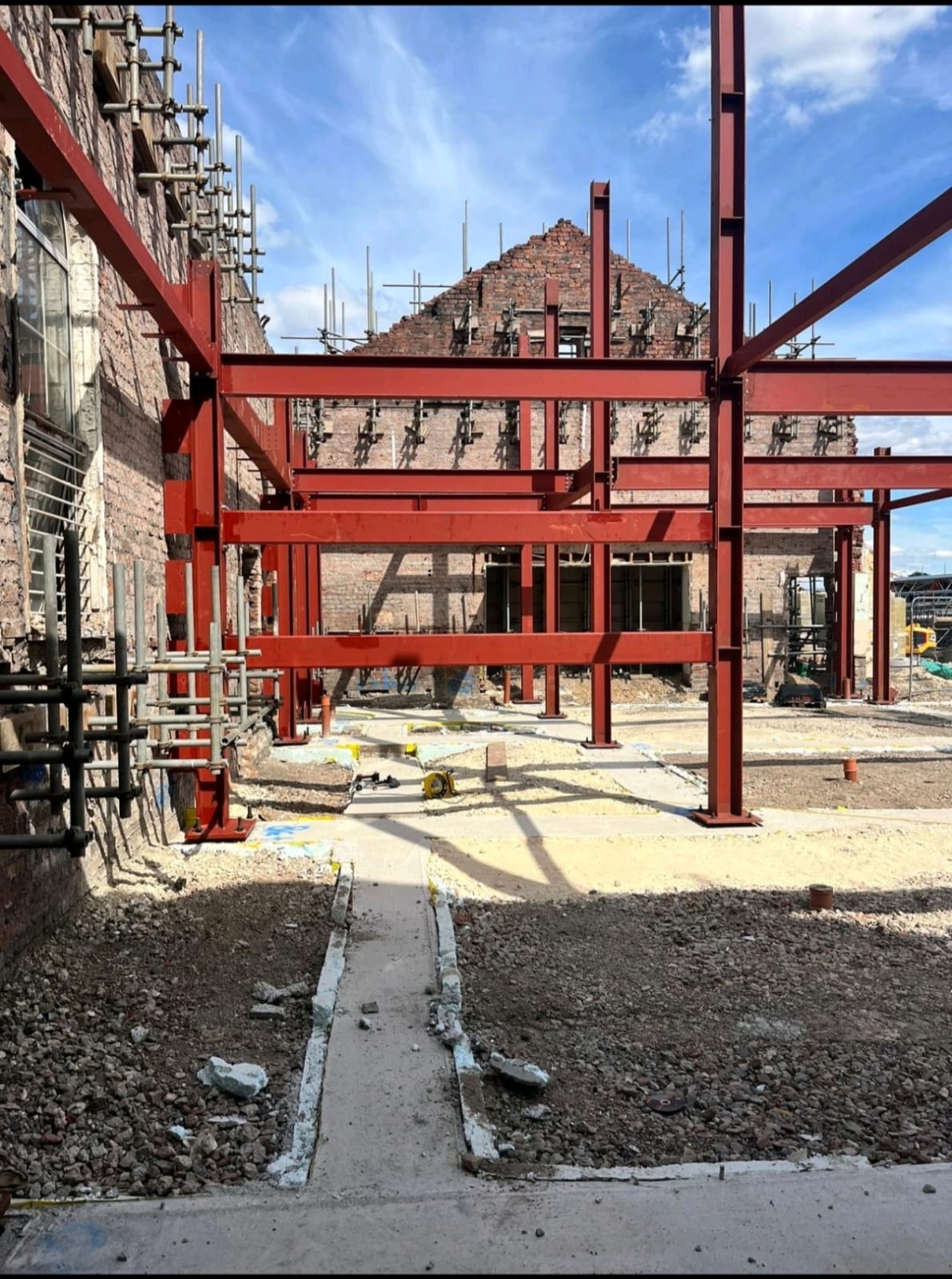 Steelwork installation in progress within constrained site